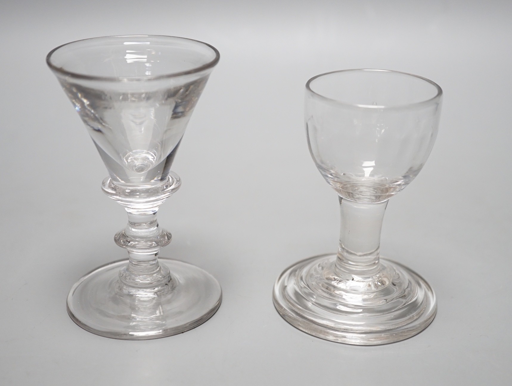 A George III dram glass, terraced foot and a similar deceptive glass, tallest 9.5cm